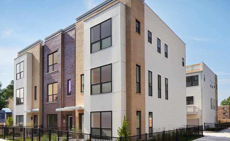 Buckingham townhomes by Lexington Homes with brick and modern panel facades